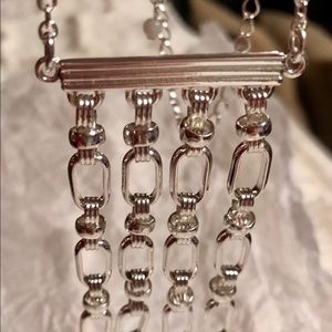 Beautiful long silver tone necklace.